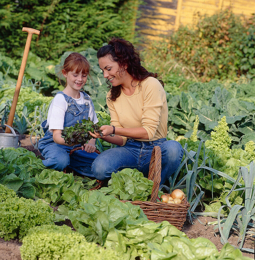 Mother and daughter in the vegetable garden
