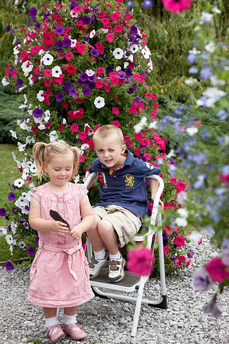 Children in front of large petunia container