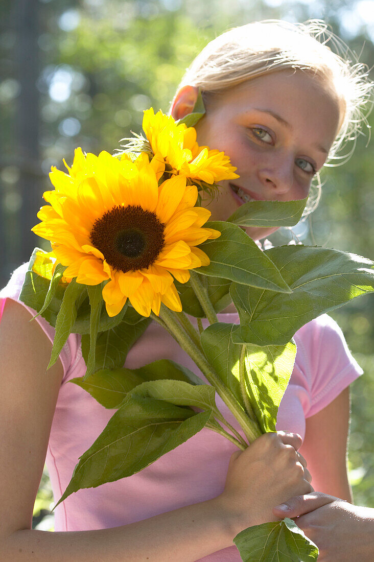 Girl holding sunflowers