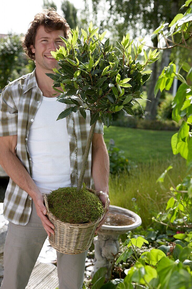 Man holding laurel tree