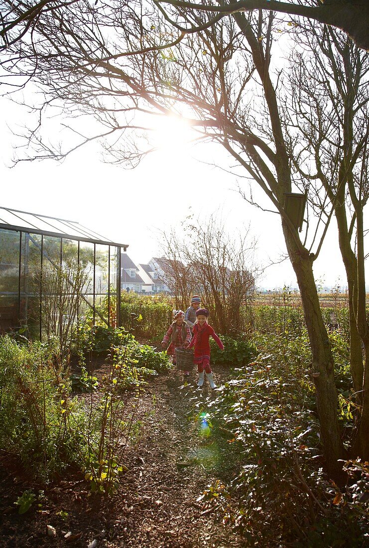 Children walking down garden path