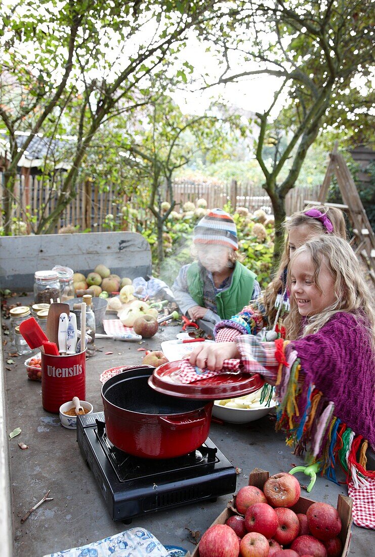 Children making apple sauce