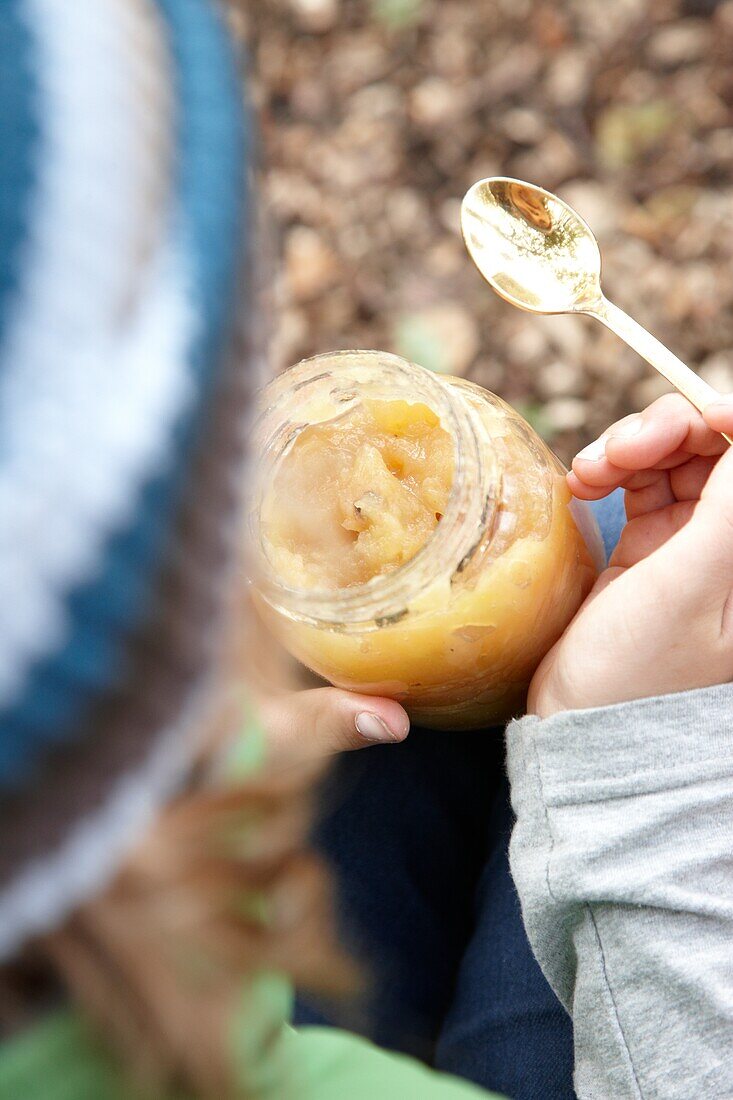 Child eating apple sauce