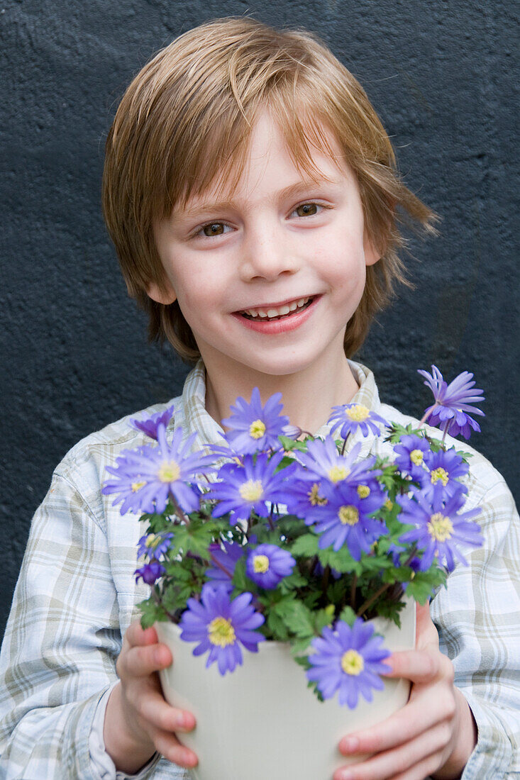 Boy holding anemone blanda