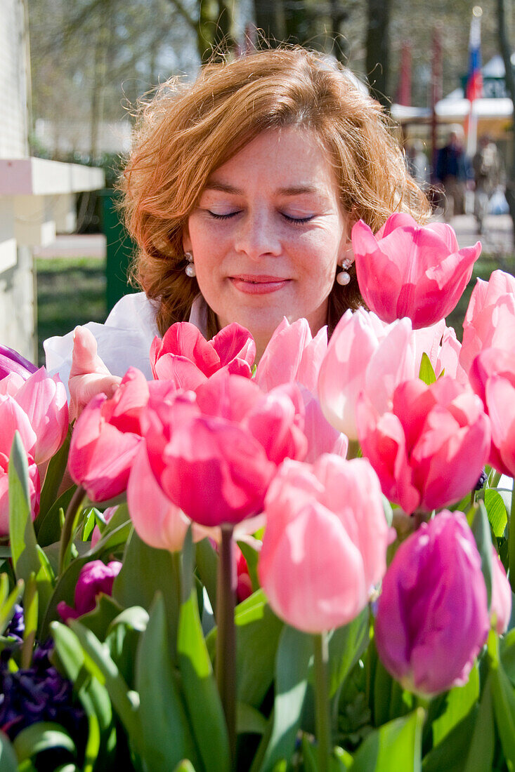 Woman smelling tulips