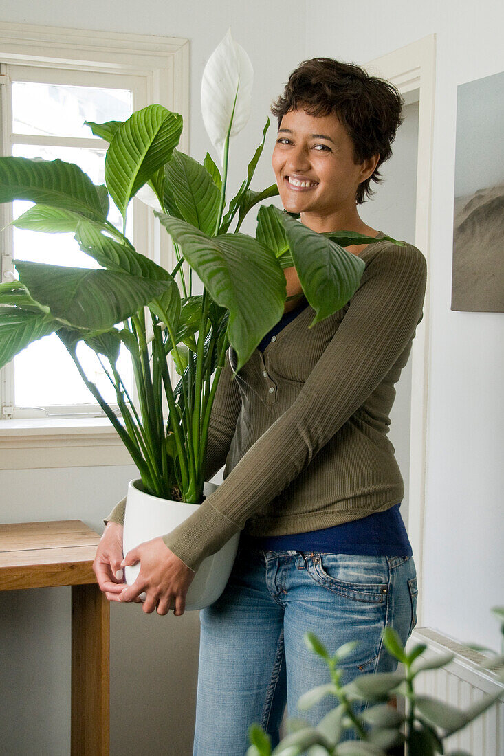 Woman holding Spathiphyllum