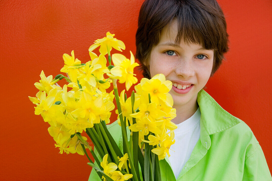 Boy holding daffodils