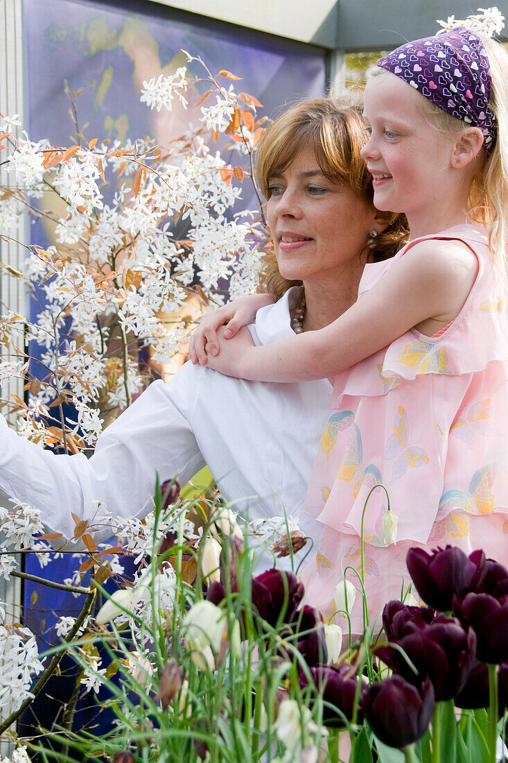 Mother and daughter on spring patio