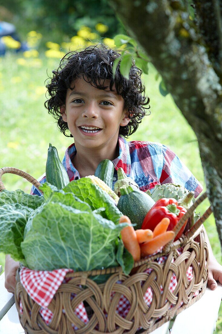 Boy holding vegetable basket