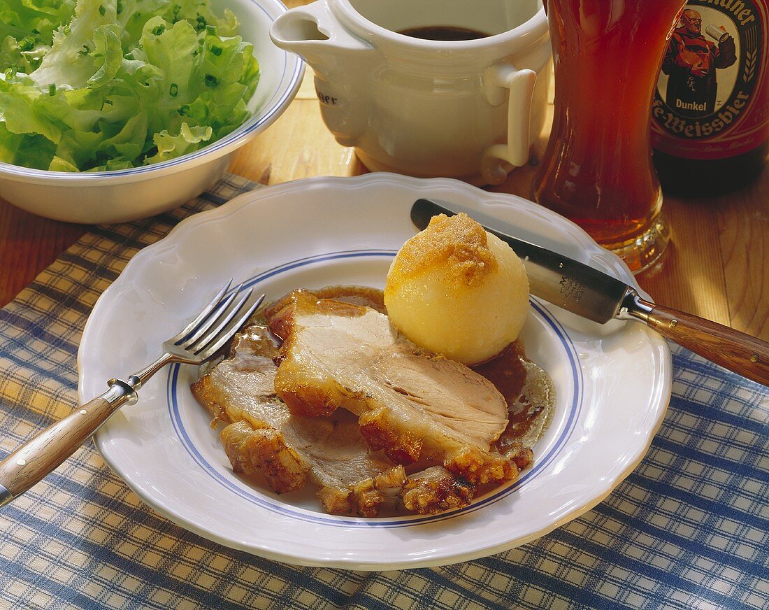 Two slices of roast pork with crackling with gravy & dumpling