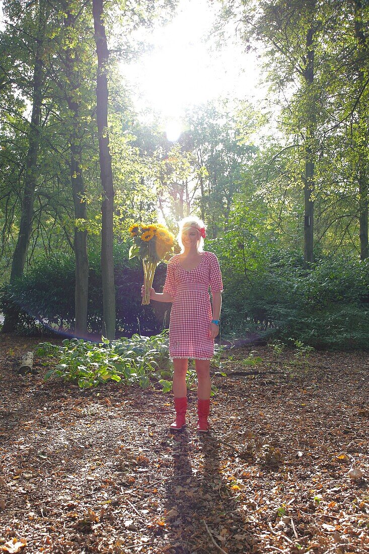 Woman holding sunflowers