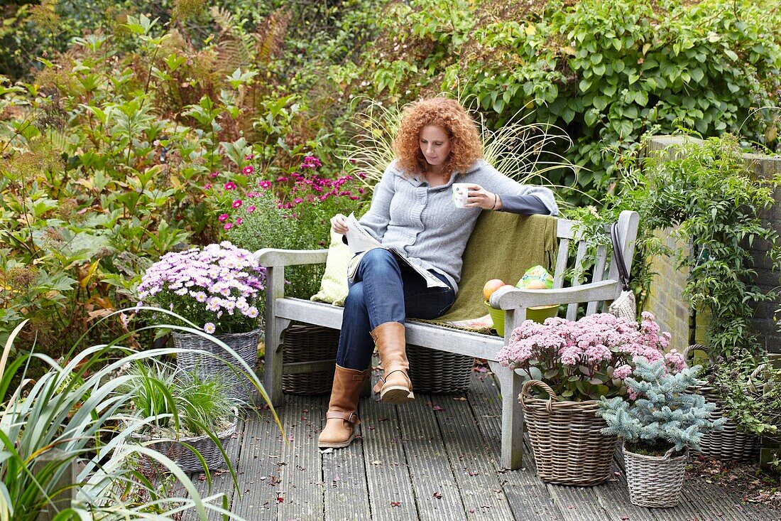 Woman relaxing on autumn terrace