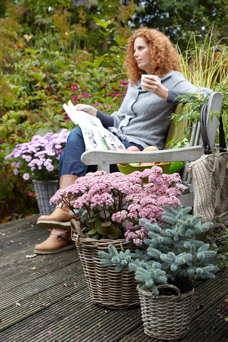 Woman relaxing on autumn terrace