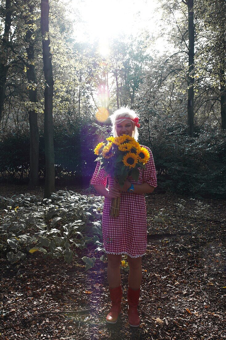 Woman holding sunflowers