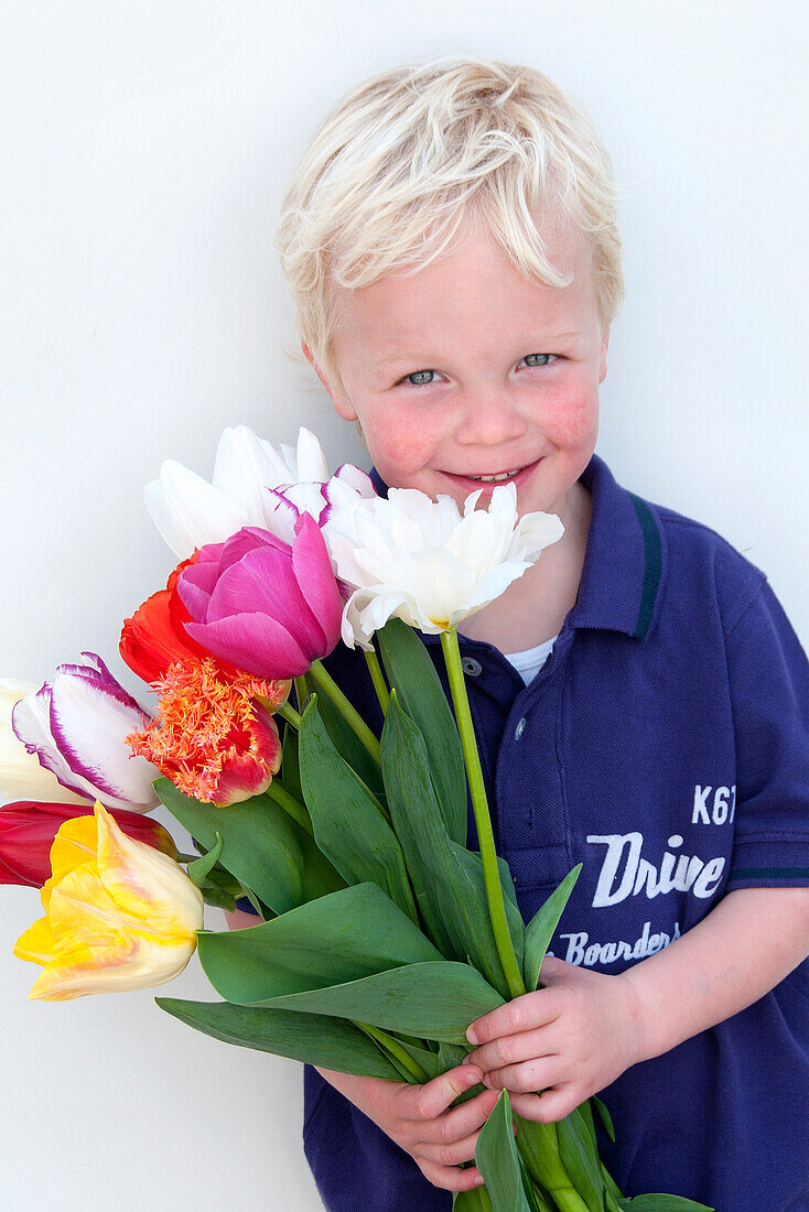 Boy holding spring flowers