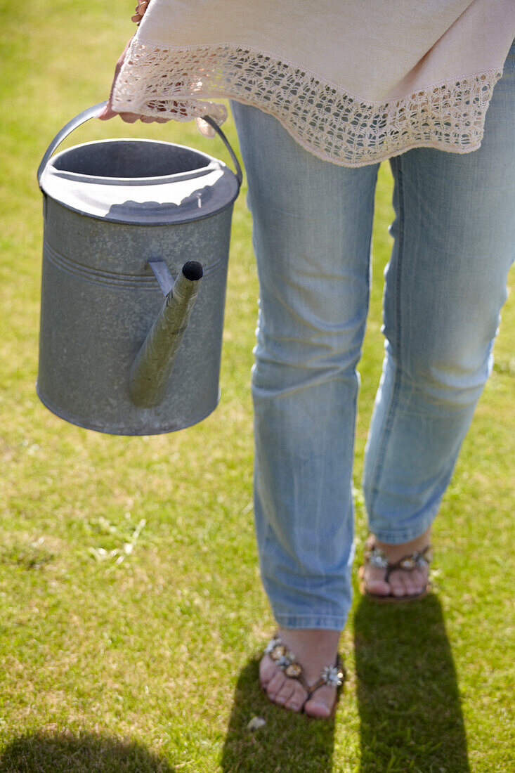 Woman holding watering can