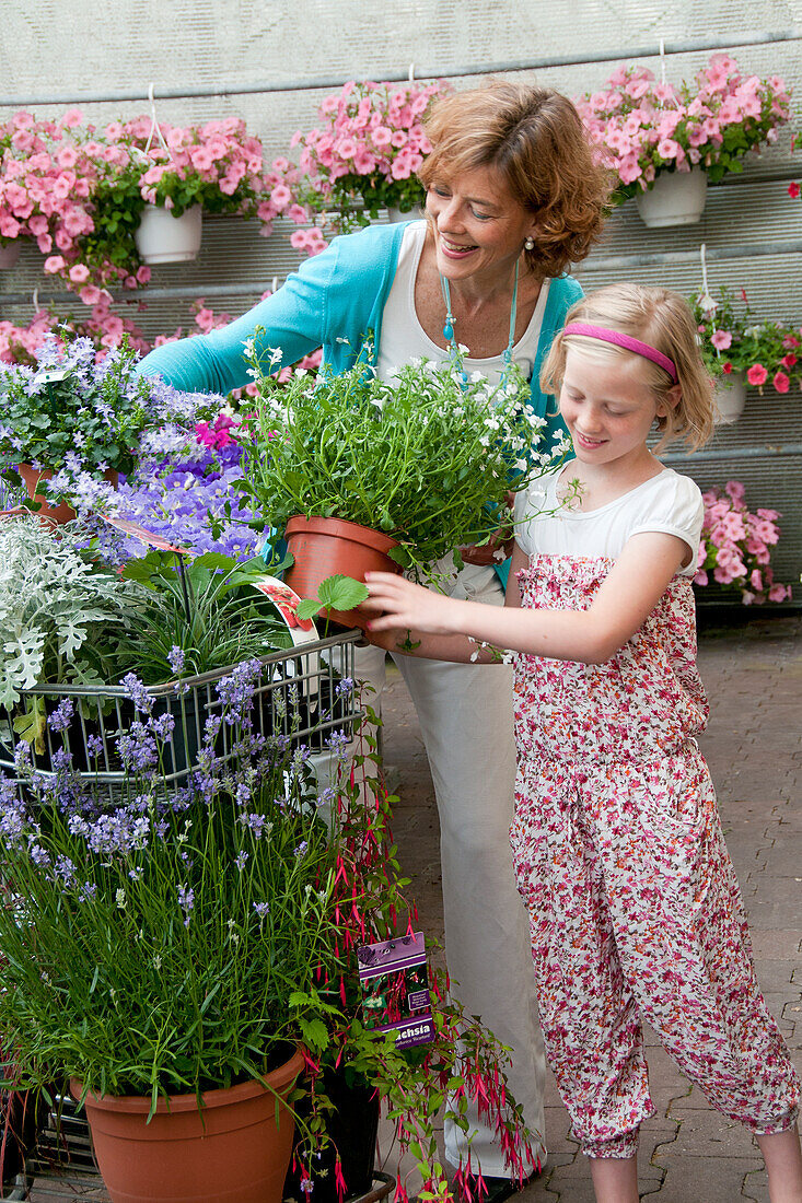 Woman buying plants in garden center