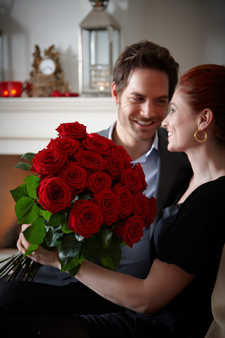 Couple holding red roses