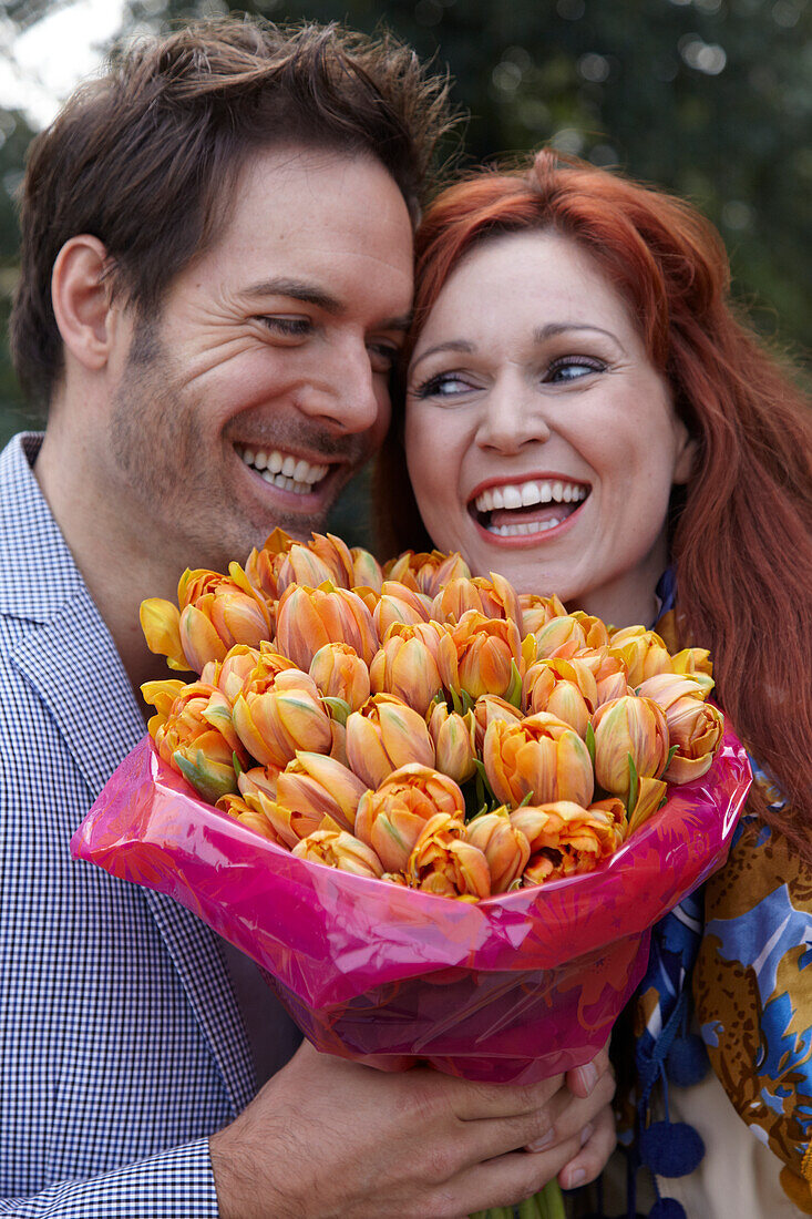 Couple holding flowers