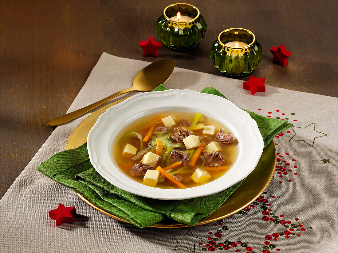 Festive beef broth with egg garnish