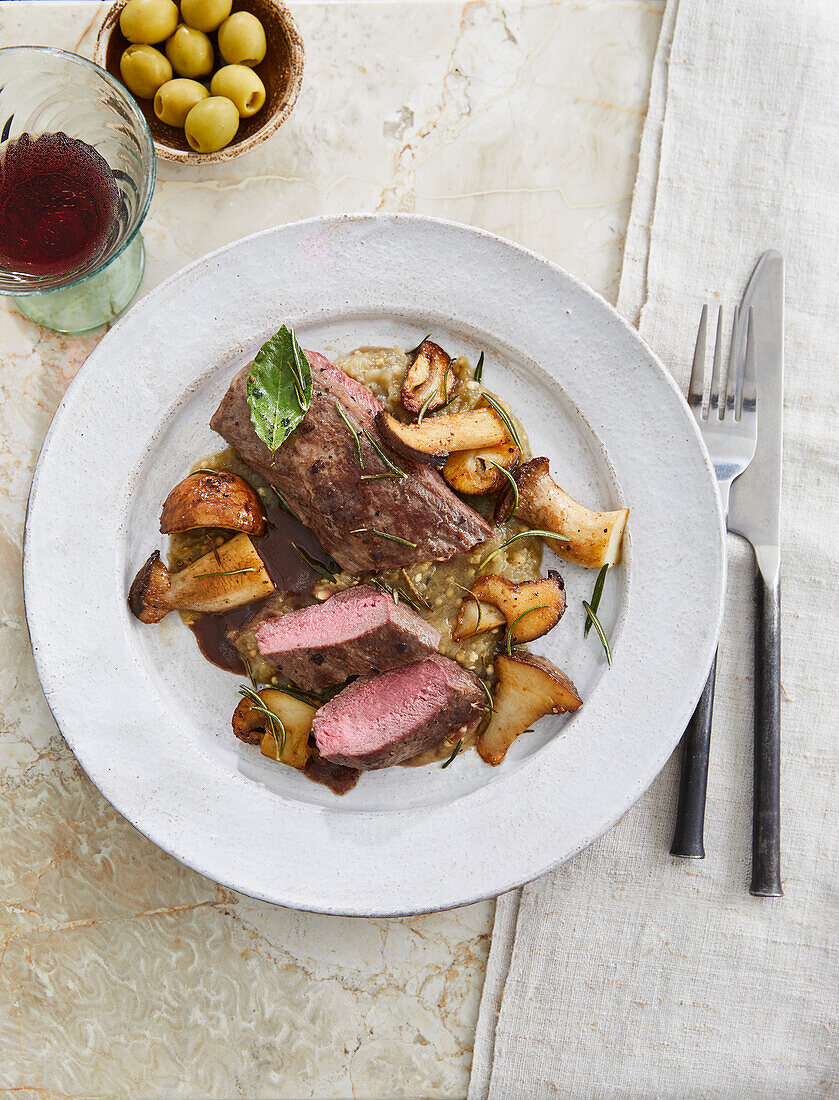 Roasted saddle of venison with mushrooms and aubergine purée