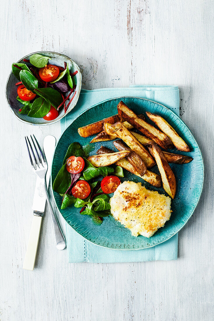 Parmesan-crusted fish with potato wedges and salad