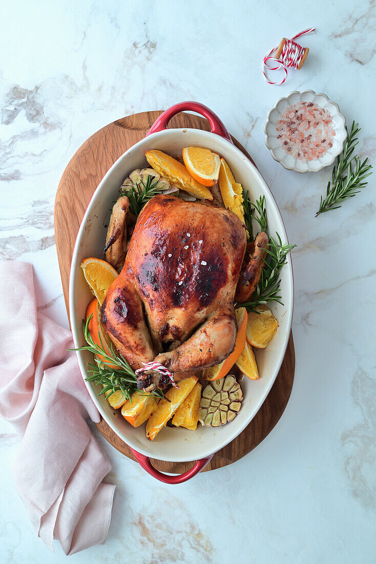 Whole baked chicken with oranges, garlic and rosemary