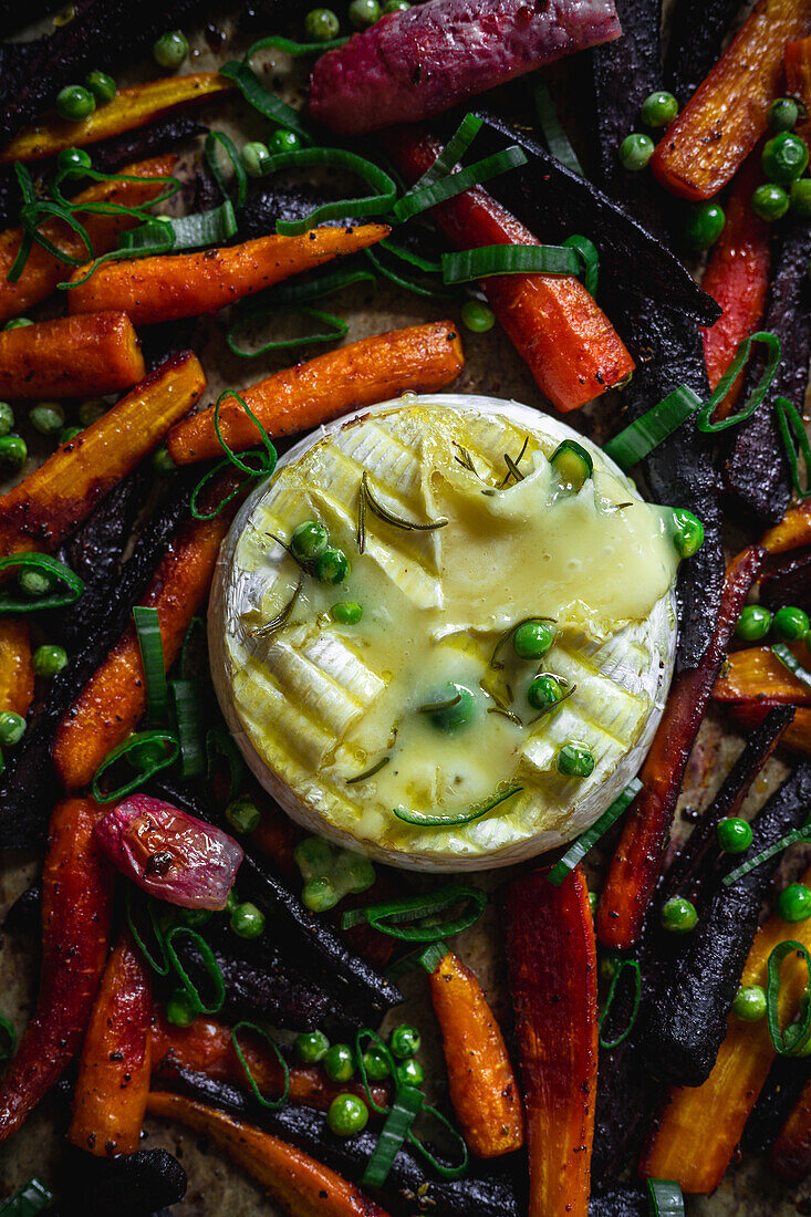Camembert oven cheese with carrots, chives and peas
