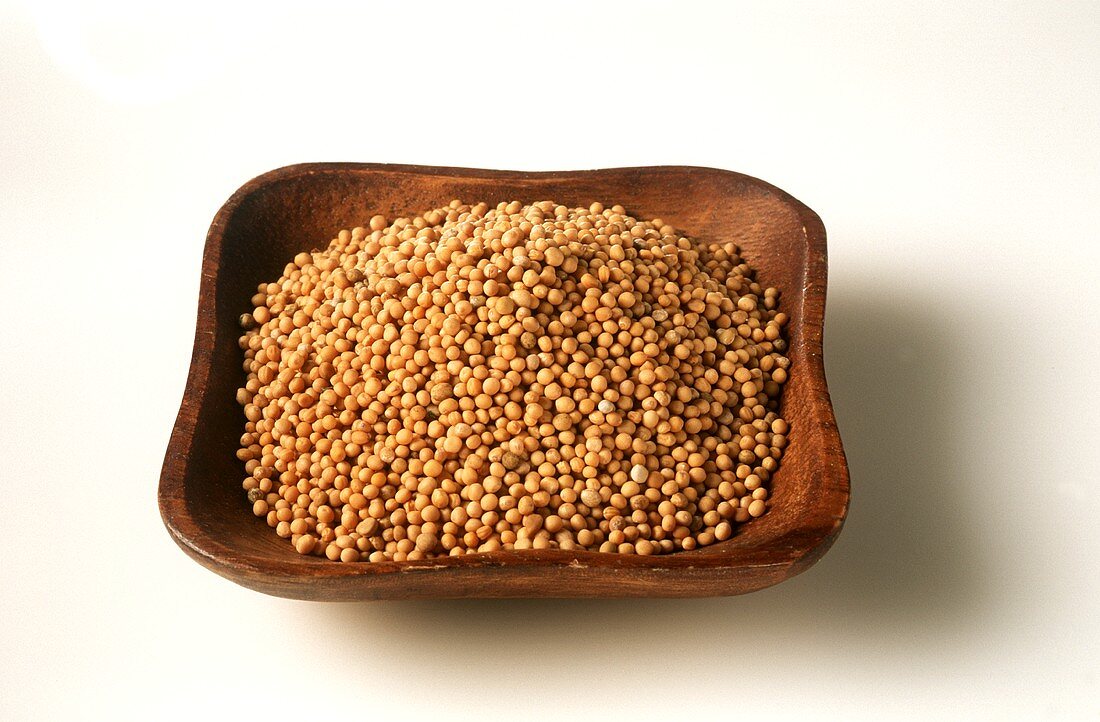 Mustard seeds in wooden bowl