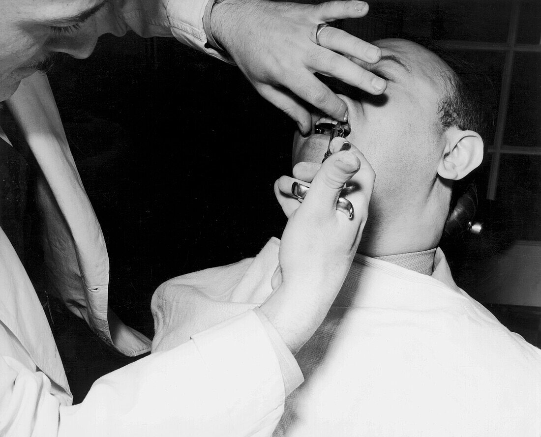 Patient receiving novocaine before tooth extraction, 1930s
