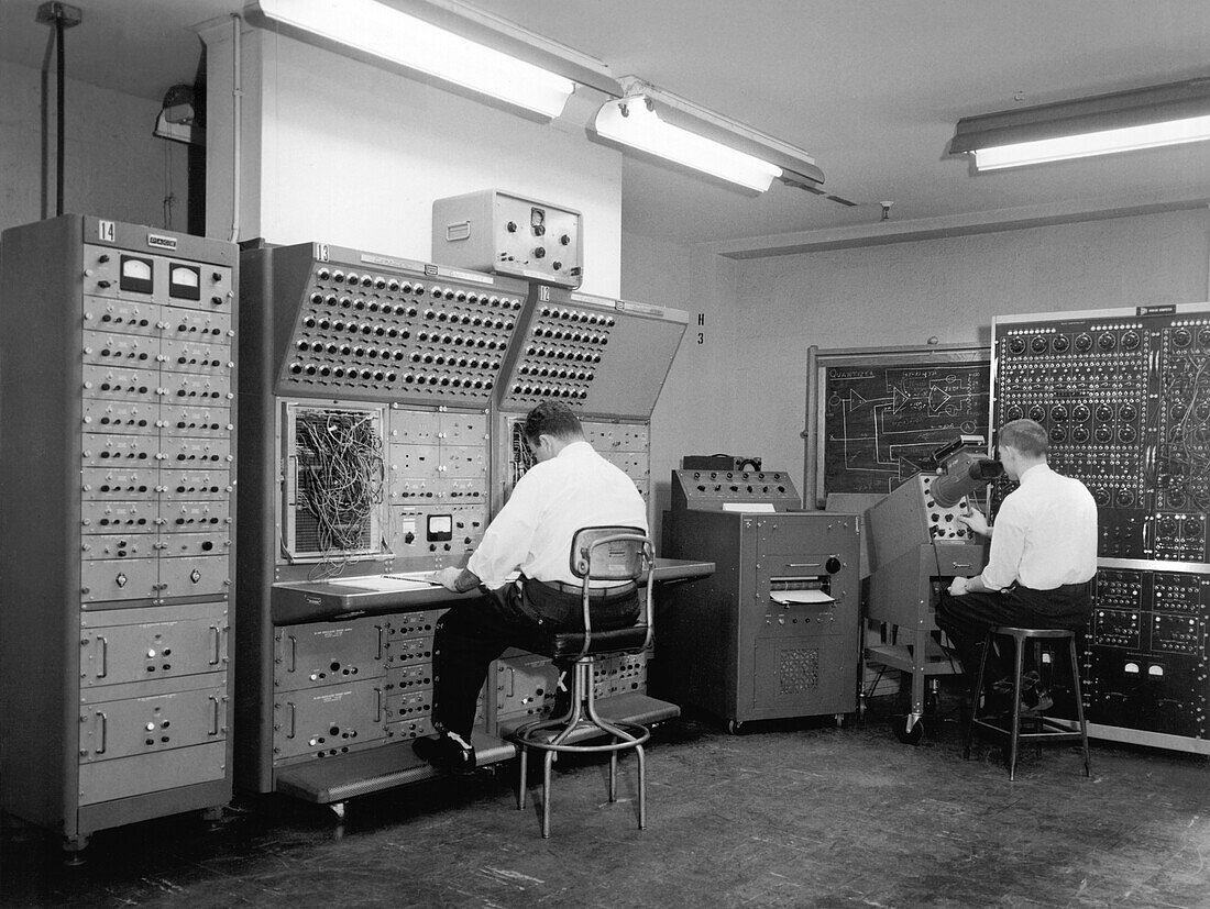 Men working on analogue computer