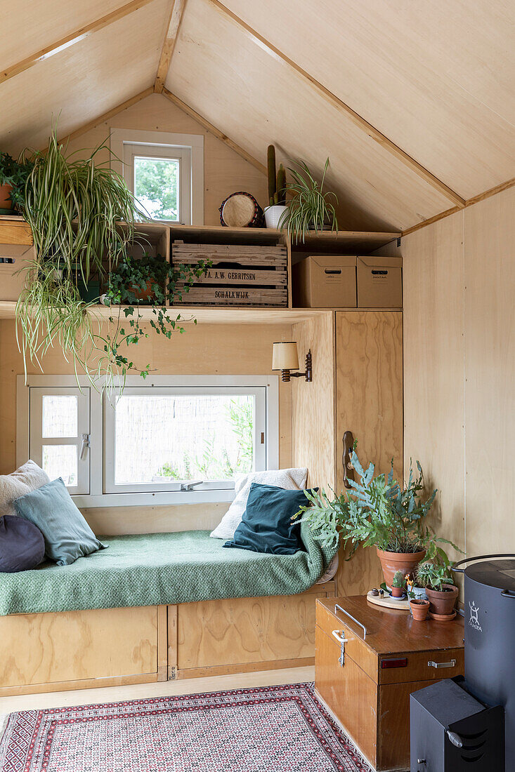 Cosy tiny house with reading corner and lots of houseplants