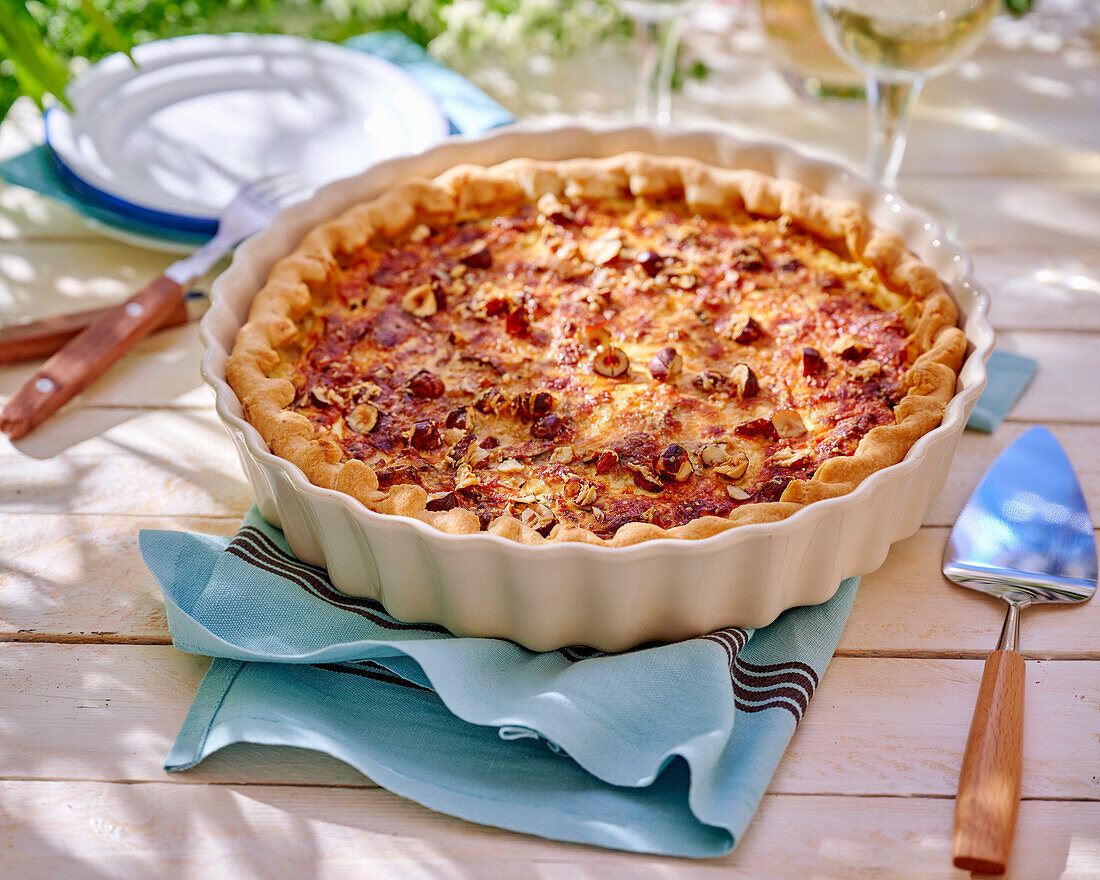 Tart with sheep's cheese, courgette and hazelnuts, sliced