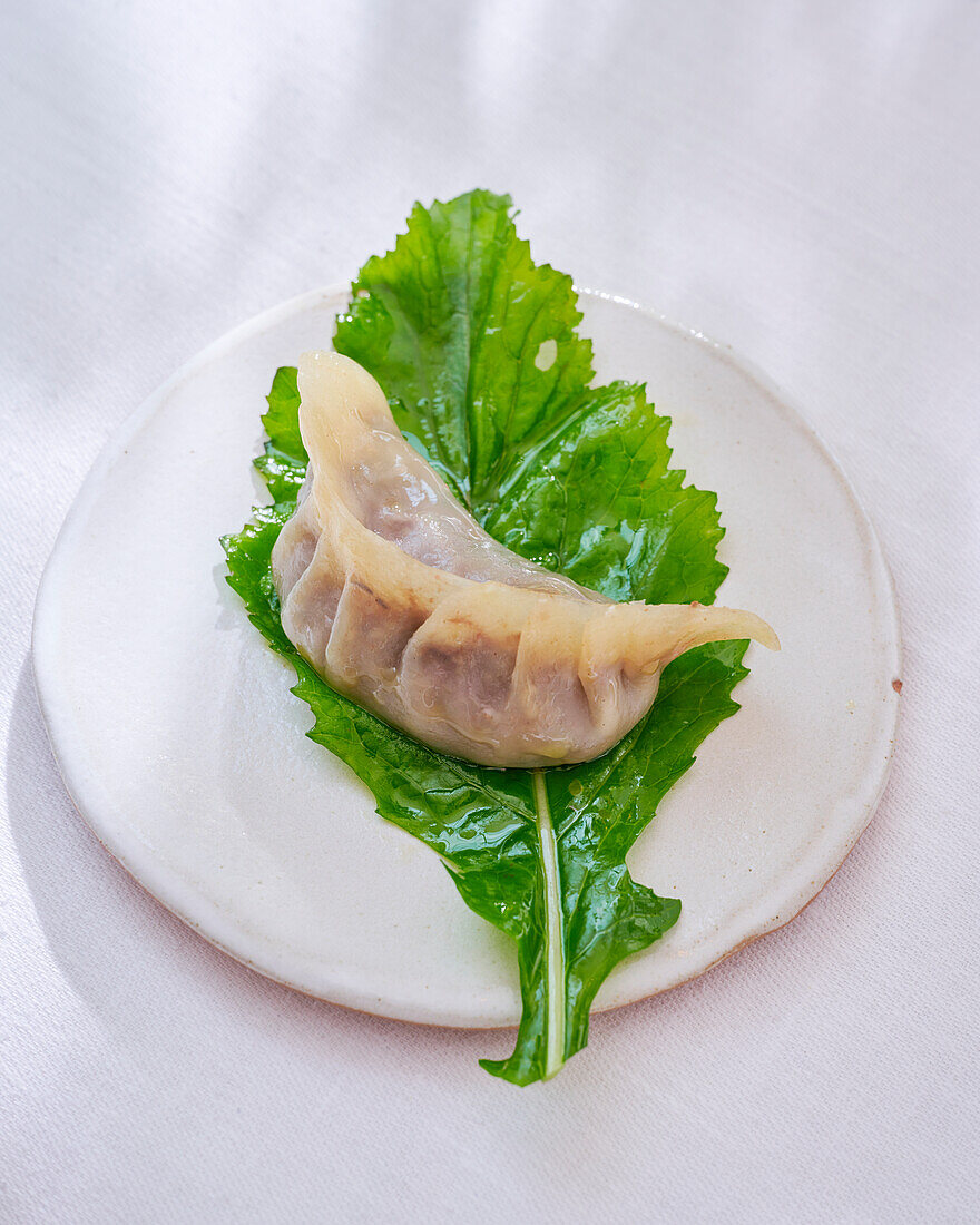 Gyoza on blanched leaves