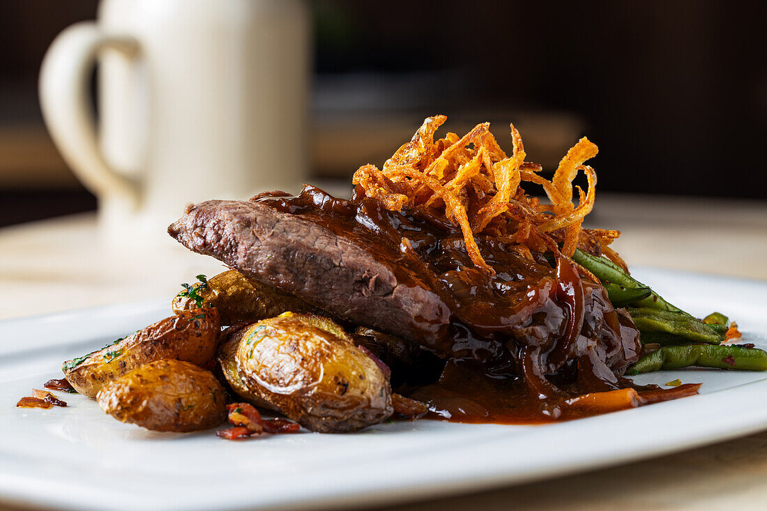 Onion roast with jacket potatoes and beans