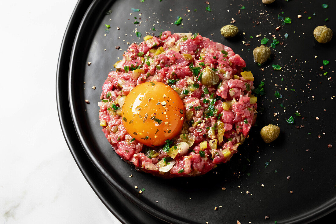 Beef tartare with egg yolk and capers