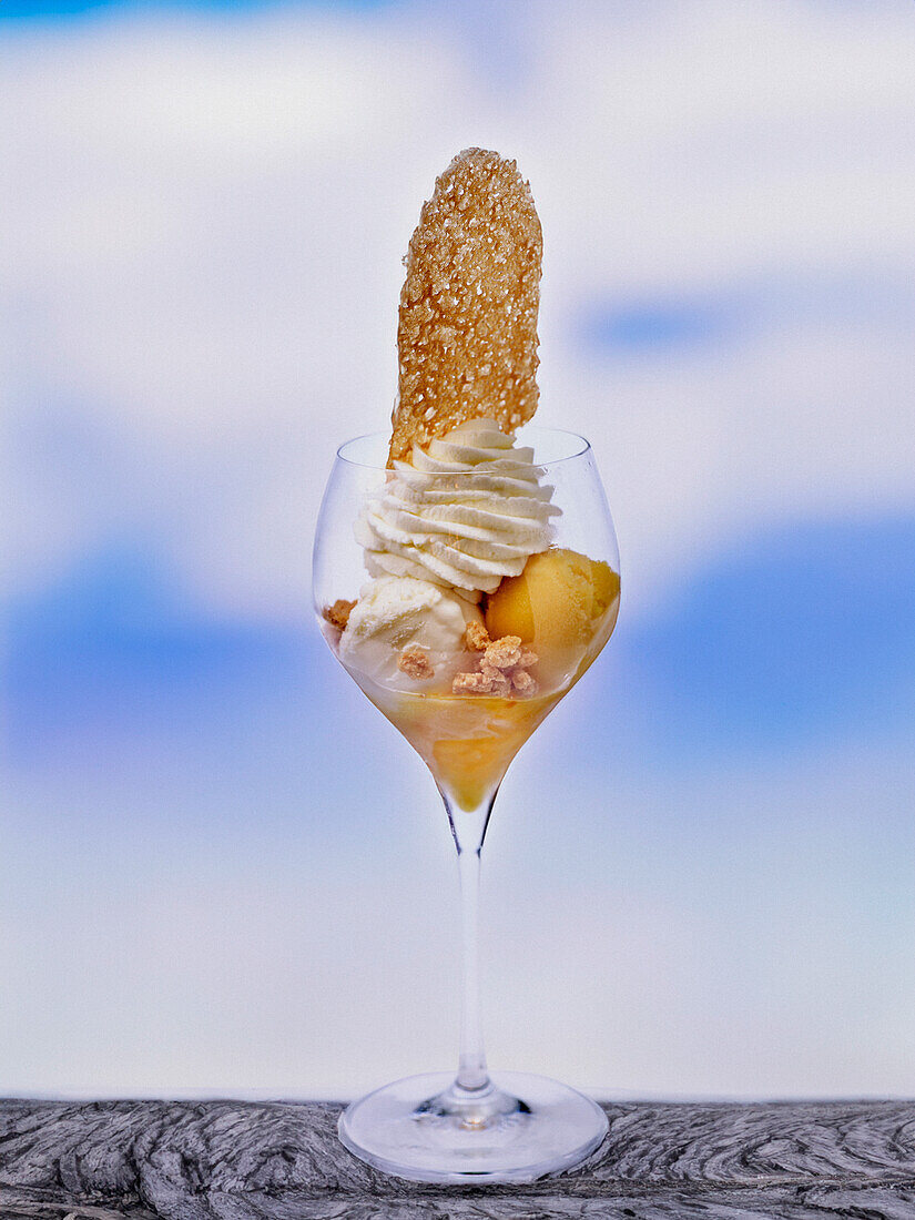 Ice cream sundae with whipped cream and brittle