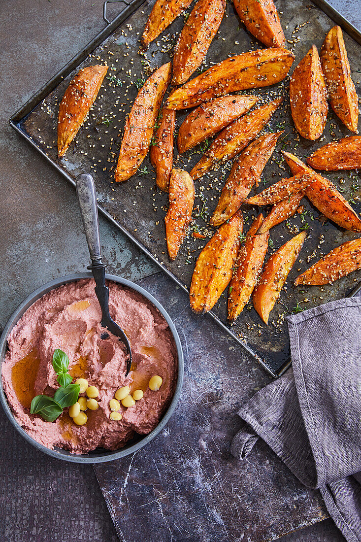 Vegan sweet potato and sesame wedges with lupin and beetroot hummus