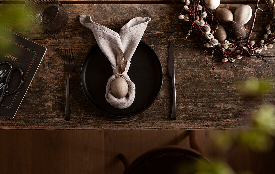 Easter table arrangement with napkin folded as bunny ears