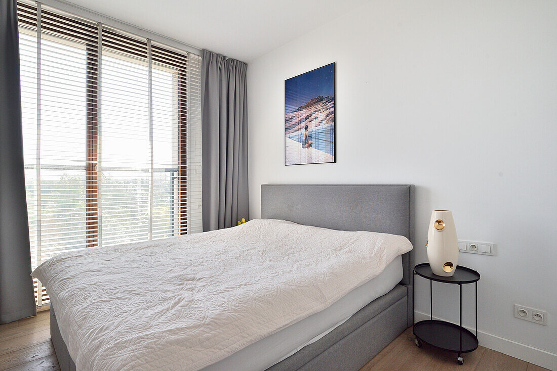 Bedroom with double bed, bedside table and blinds in Warsaw flat