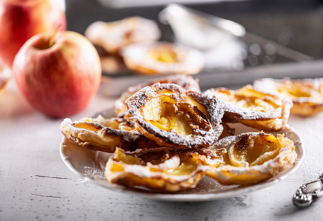 Mini puff pastry apple tartlets with icing sugar