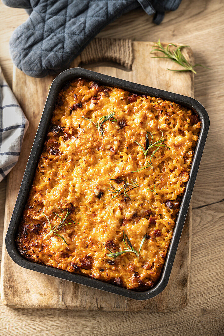 Pasta casserole with smoked meat, sausage, egg, cheese and herbs