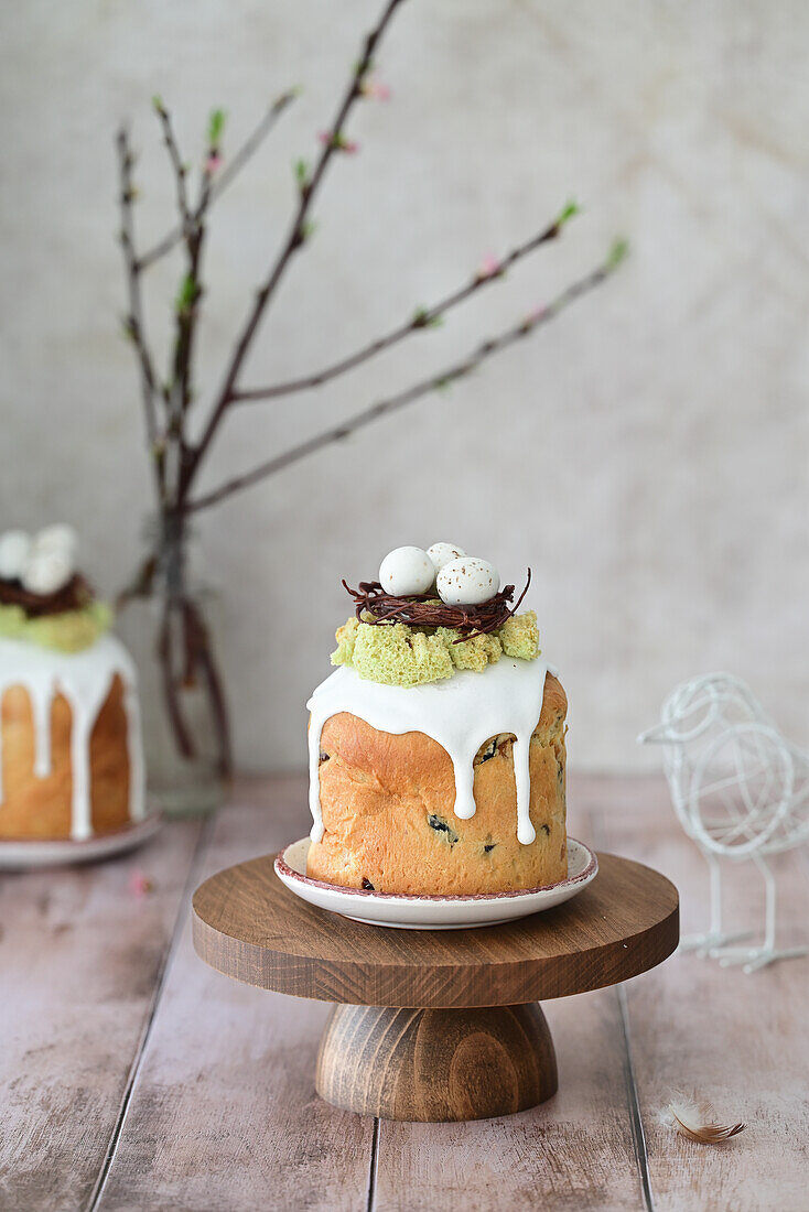 Kulich with candied fruit, decorated with a chocolate nest and sugar eggs