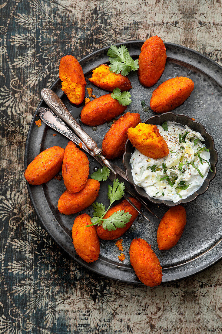 Baked pumpkin and saffron falafel with cucumber raita