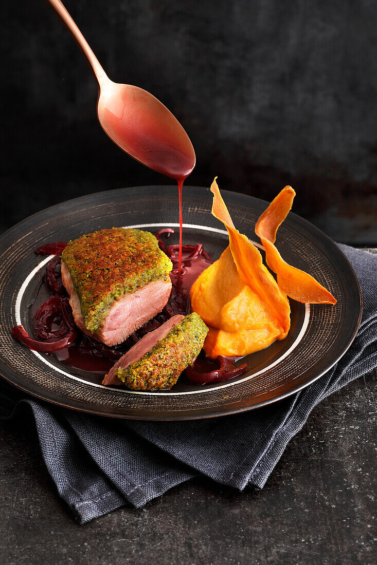 Duck breast with pistachio and rosemary crust, port wine onions and sweet potato puree