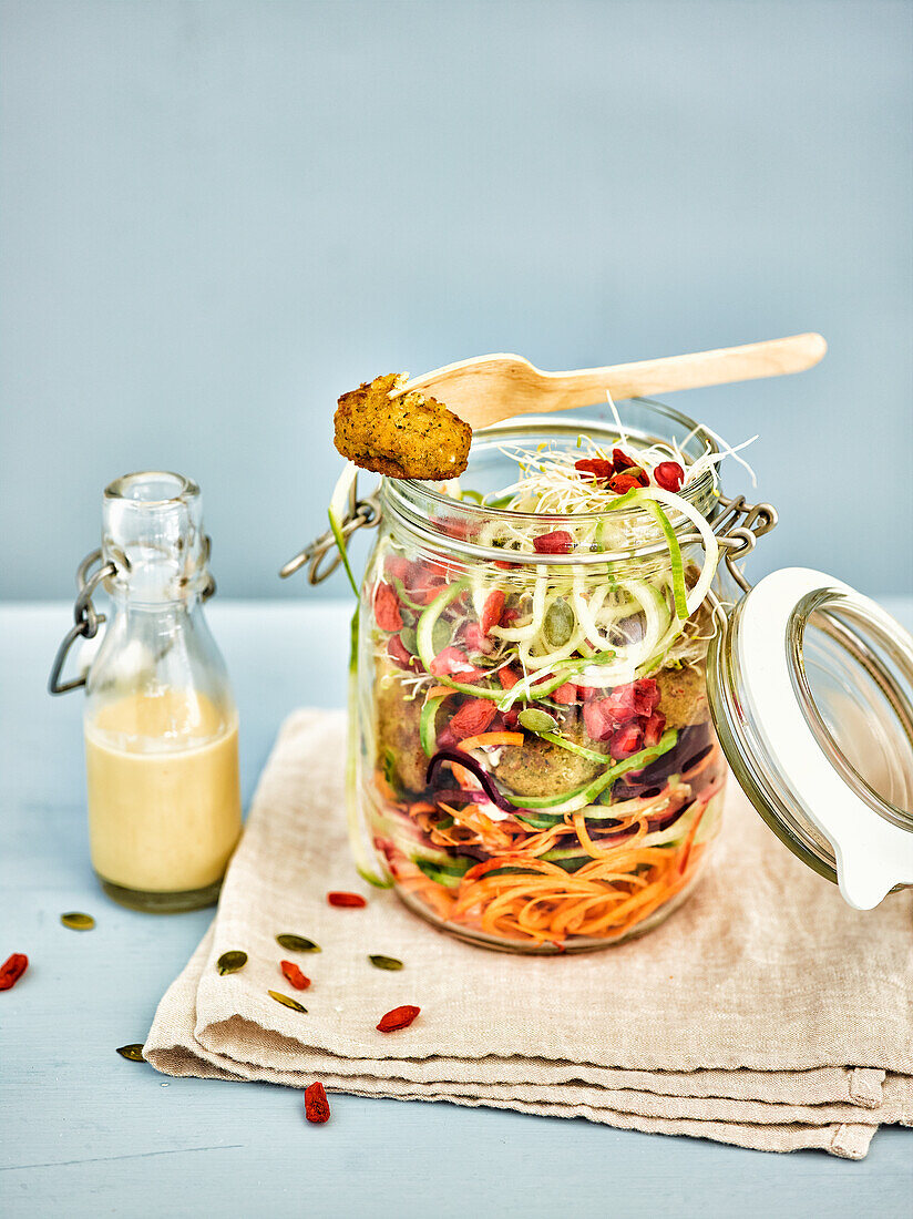 Vegetable spaghetti with falafel in a glass