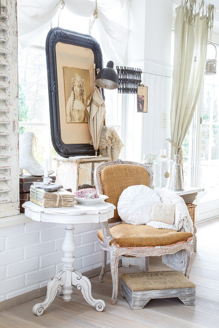 Vintage-inspired living area with antiques in light colours