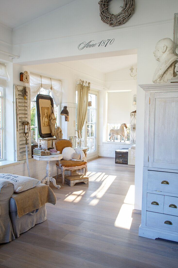 Bright living room in shabby chic style with antique furniture and accessories