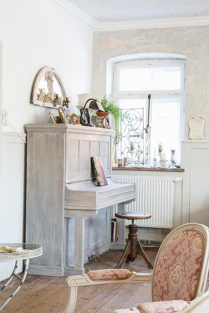 Vintage furniture and piano in bright living room