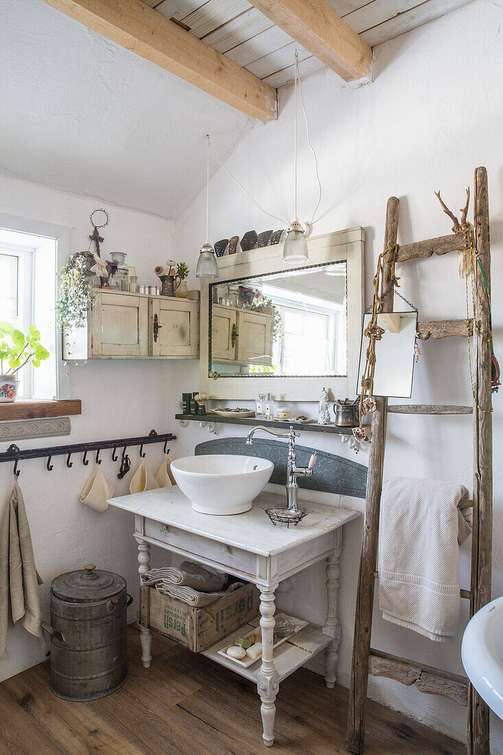 Rustic bathroom with vintage ladder and antique washbasin